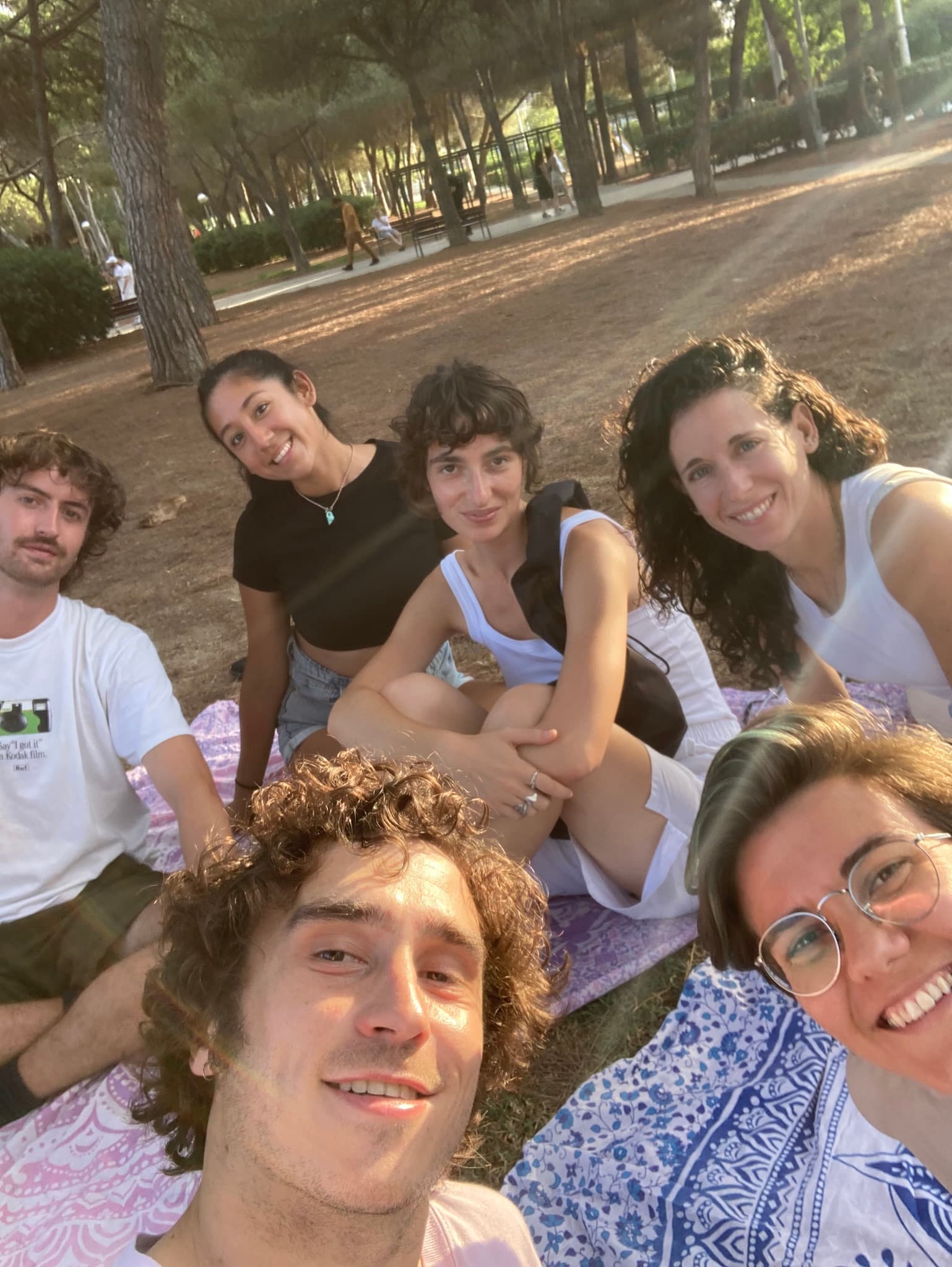 A group of friends enjoying a picnic together in a sunny park